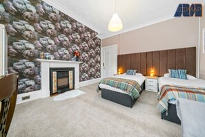 Spacious Elegance: Enjoy the flexibility of two single beds that can be combined into a superking, complemented by a striking wall-filling headboard for added sophistication