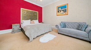 Relax and Unwind: Featuring two single beds that can be combined into a super king, a comfortable sofa, dresser/desk and chair, wardrobe, and a window offering natural light—everything you need for a restful stay