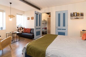 Bright and welcoming apartment with a cozy seating area and bed — perfect for relaxing after a day of exploring Alkmaar.