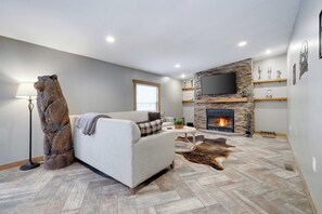 "Relax in the cozy living room, complete with a wood-burning fireplace—the perfect spot to unwind after a day of adventure in the Poconos.