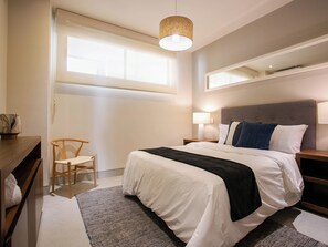 The second bedroom offers a cozy queen-size bed, providing a comfortable and inviting space for a restful night’s sleep.