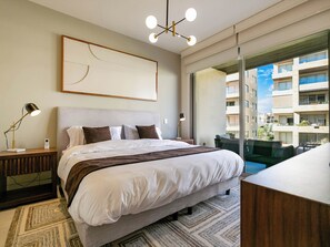 The master bedroom features a luxurious king-size bed and a private ensuite bathroom, offering a serene retreat with ultimate comfort and convenience.