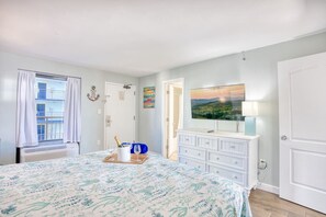 Amazing master bedroom with views of the 10th floor rooftop pool, plenty of storage options, Smart TV, and large king-sized bed.