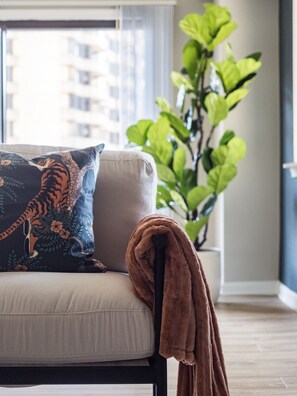 Step into this living room, where comfort meets style. The soft pillows and luxurious blanket are perfect for you to snuggle into while watching a movie or enjoying a quiet evening.