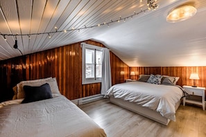 Bedroom with one twin bed and one queen bed