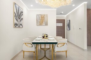 Dining Room: Enjoy meals under a stunning chandelier in this elegant, contemporary space!