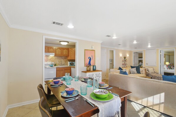 Dining into Living and Kitchen- place settings for 6, TV view, very stylish