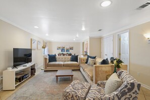 Living- 2 large sofas, chair with footrest, TV, games, record player, lighting