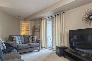 Open living room with comfortable couches looking out to the mountains. 