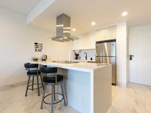 The kitchen features a stylish counter with bar seating, creating a casual and convenient space for dining, socializing, or enjoying your morning coffee.