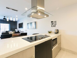 The kitchen features a stylish counter with bar seating, creating a casual and convenient space for dining, socializing, or enjoying your morning coffee.