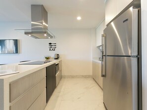 The modern kitchen is fully equipped with everything you need for a convenient and enjoyable stay. With sleek countertops, stainless steel appliances (excluding an oven), and ample storage, it’s perfect for preparing anything from quick snacks to light meals. The open layout flows seamlessly into the dining and living areas, keeping you connected with family and friends while c...