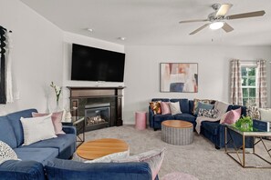 Imagine your crew in this spacious first-floor living room with a crackling fire