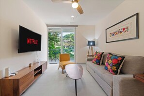 Relax in the living room with a sofa bed, smart TV, and balcony hot tub.
