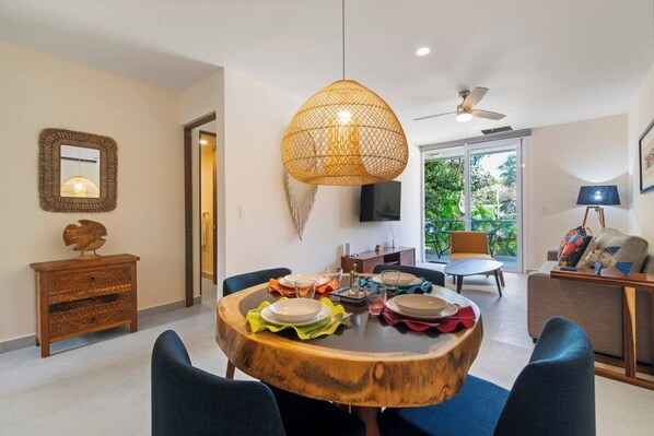 Cozy dining with a parota table for 4, AC, and full silverware.