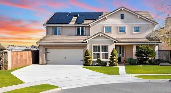Spacious and inviting home with a beautifully maintained front yard and plenty of driveway space.