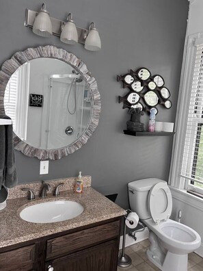 The bathroom is designed for comfort, with a spacious shower and elegant fixtures that make every moment feel luxurious.