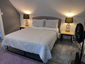 The bedroom’s serene ambiance invites you to relax, with a plush bed that promises a restful night's sleep.