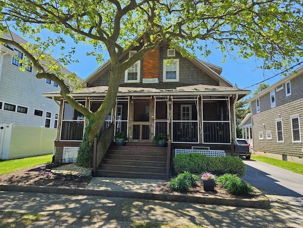Enjoy coastal or lake breezes sitting on the screened front porch of this quintessential beach cottage!