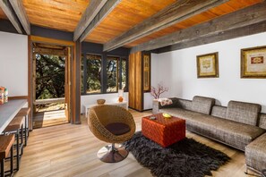 Cozy meets contemporary in this stylish lounge space! Featuring exposed wood beams, modern furnishings, and seamless indoor-outdoor flow for ultimate relaxation.