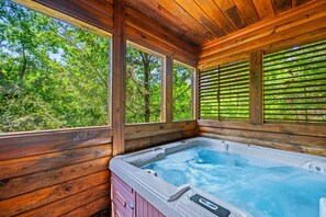 Unwind and relax in the private hot tub, where warm, bubbling waters and serene surroundings create the perfect escape