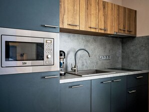 Kitchen, Kitchen Appliance, Countertop, Cabinetry, Major Appliance, Home Appliance, Interior Design, Wood, Flooring, Kitchen Stove