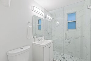 Refresh and rejuvenate in this modern bathroom after a day of sun and sand.