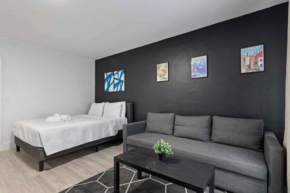 Cozy bedroom with modern decor and a comfortable sofa, perfect for relaxation after a day of exploring.