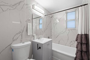 Elegant bathroom with marble accents and modern fixtures, perfect for a relaxing retreat.