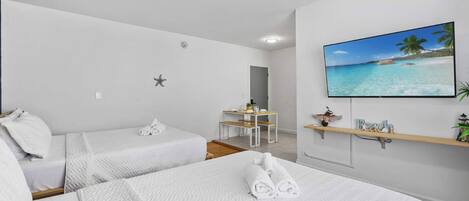 Your stylish urban oasis awaits! Unwind in this modern studio with two comfy queen beds and all the essentials for a perfect beach getaway.