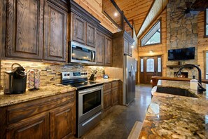 The inviting, open kitchen offers ample space & every home comfort