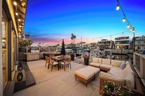 Savor the waterfront patio with hot tub and cozy seating