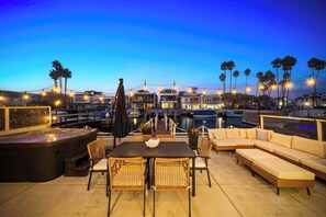 Savor the waterfront patio with hot tub and cozy seating