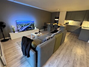 Spacious living area with open kitchen that has a sociable kitchen island
