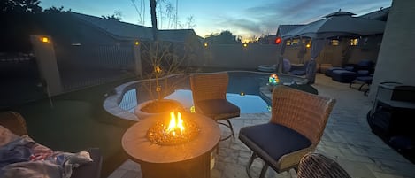 Fire pit (propane included) overlooking private pool and putting green.