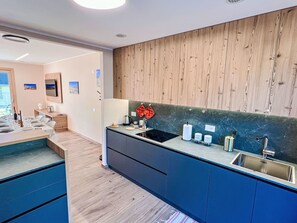 Flooring, Wood, Interior Design, Countertop, Kitchen, Floor, Cabinetry, Furniture, Room, Major Appliance