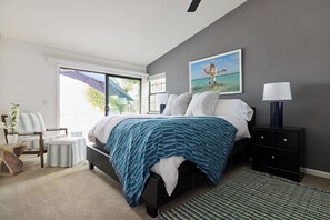 Primary Bedroom - King size bed with luxury sheets, private patio and ensuite bathroom with walk in shower, dual sinks, walk in closet, ceiling fan.
