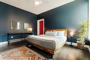 King bed with black out shades in the windows