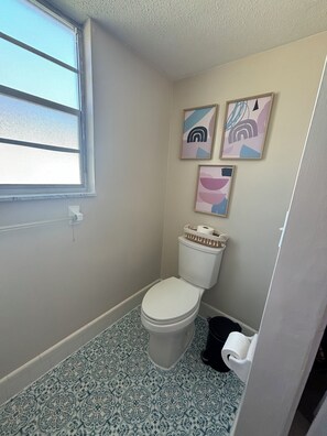 2nd bathroom.  Vanity with starter pack of toiletries.  Bathtub with shower