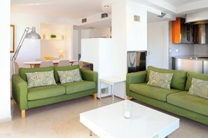 Living area, with adjacent kitchen and dining area 