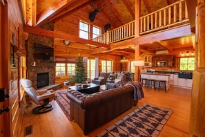 The main floor with living space, dining room and kitchen area. Loft up above contains the rec room with its own separate TV and speaker system, pool table, Pac-man arcade game and yoga mat storage.