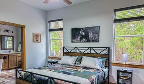 The spacious king bedroom has a smart TV, couple books and ceiling fan.
