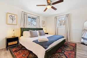 King sized bed with full length mirror, closet, and blackout curtains. 