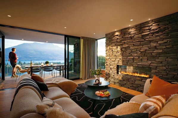 Cozy Living Room with Gas Fireplace & Lake Views
The inviting living room features a gas fireplace, creating a warm ambiance while offering stunning views of Lake Wakatipu.