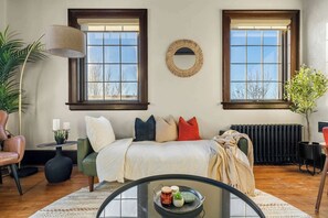 A stylish futon in the living room serves as both a comfortable seating area and an extra bed for guests