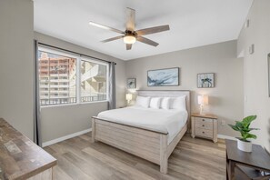 Master bedroom with a comfortable king-size bed, flat-screen TV, and stunning ocean views.