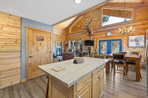 Features a spacious kitchen with a large countertop that provides ample space for seating, making it the perfect spot to gather with family or friends.