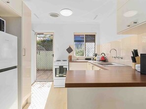 Prepare delicious meals in this well-equipped kitchen, complete with modern appliances, and a dining area for enjoying your culinary creations.