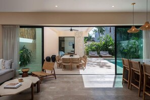 Elegant and bohemian open concept ground floor. Large windows connect to the outside and allow in natural light.
