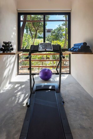 Gym inside the villa with views of the outdoors.
